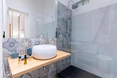 a bathroom with a white sink and a shower at SarAle Apartments in Palermo