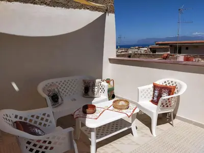 a white table and chairs on a balcony at AFFITTACAMERE LE SIGNORINE in Castellammare del Golfo