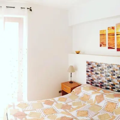 a bedroom with a bed and a window at AFFITTACAMERE LE SIGNORINE in Castellammare del Golfo