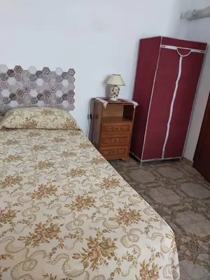a bedroom with a bed and a dresser and a night stand at AFFITTACAMERE LE SIGNORINE in Castellammare del Golfo