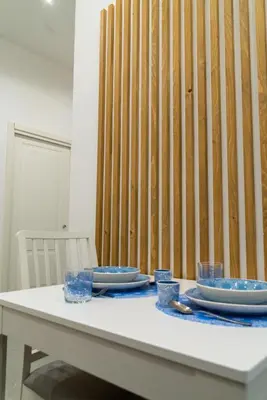 a white table with plates and glasses on it at Nena Sweet Home in Palermo