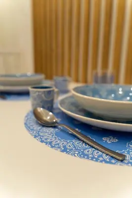 a table with plates and bowls and a spoon at Nena Sweet Home in Palermo