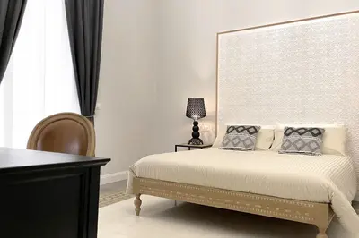 a bedroom with a bed with a large headboard at Dimora Borghese “Whitaker” in Palermo