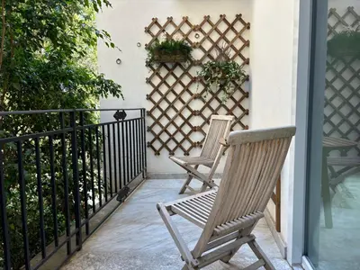 two chairs sitting on a porch with a fence at Dimora Borghese “Whitaker” in Palermo