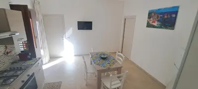 a kitchen with a table and chairs in a kitchen at Mamma Rosa Casa Vacanze in Castellammare del Golfo