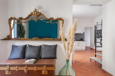a living room with a couch and a mirror at Suk Ballarò House in Palermo