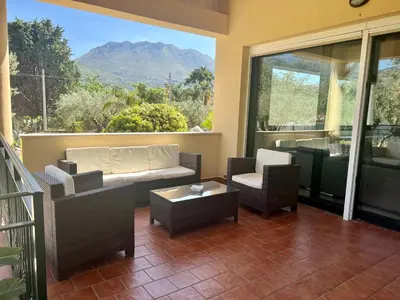 a living room with a couch and chairs on a balcony at Via delle Rose in Torretta