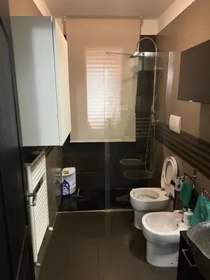 a bathroom with two toilets and a shower at Via delle Rose in Torretta