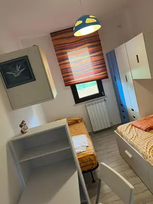 a small bedroom with a bed and a window at Via delle Rose in Torretta
