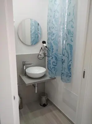 a bathroom with a sink and a mirror at Casa vacanze Venere in Balestrate