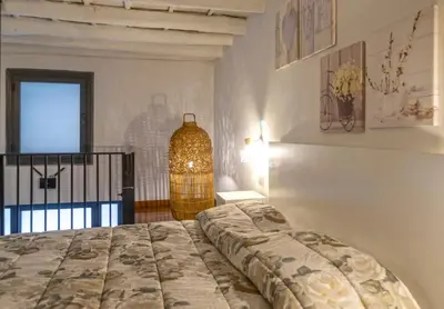 a bedroom with a bed and a vase on the wall at Casa dei Principi di Belvedere in Palermo