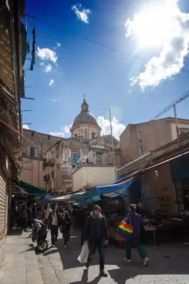 a group of people walking down a street in a market at Casa dei Principi di Belvedere in Palermo