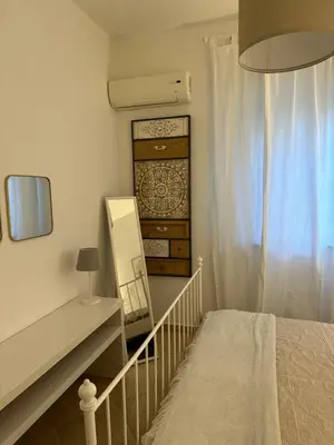 a bedroom with a bed and a dresser and a mirror at La Kalsa di Somavi in Palermo