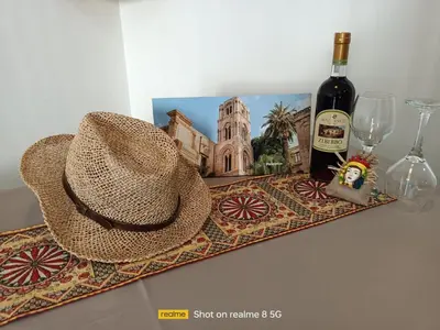 a hat and a bottle of wine on a tray at 'A Sicula in Palermo