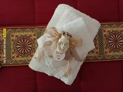 a napkin with a statue of a head on it at 'A Sicula in Palermo