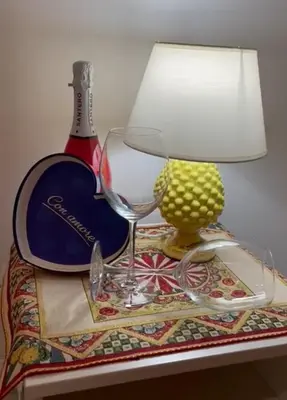 a lamp and a wine glass on a table at 'A Sicula in Palermo