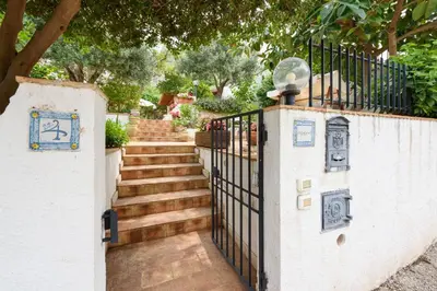 a gate with a staircase leading up to a house at Casa ChiaraMarina in Macari