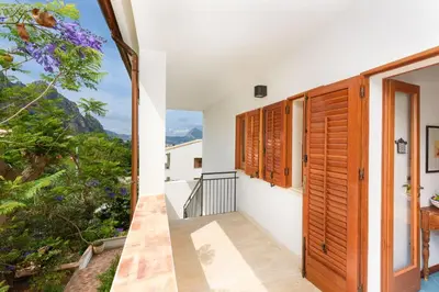 a room with a balcony with a view of the mountains at Casa ChiaraMarina in Macari