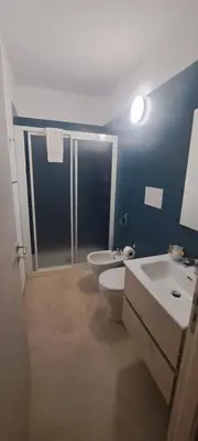 a bathroom with two sinks and a toilet and a shower at Mamma Rosa Casa Vacanze in Castellammare del Golfo