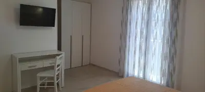 a bedroom with a desk and a television and a window at Mamma Rosa Casa Vacanze in Castellammare del Golfo