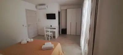 a bedroom with a bed and a desk in a room at Mamma Rosa Casa Vacanze in Castellammare del Golfo