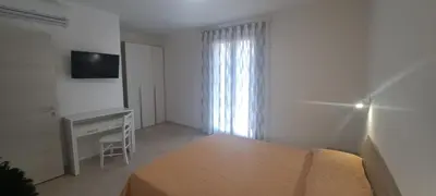 a bedroom with a bed and a desk and a television at Mamma Rosa Casa Vacanze in Castellammare del Golfo