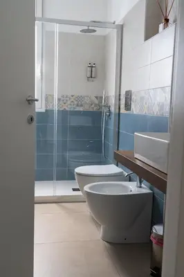 a bathroom with a toilet and a sink and a shower at B&B Alba in Terrasini