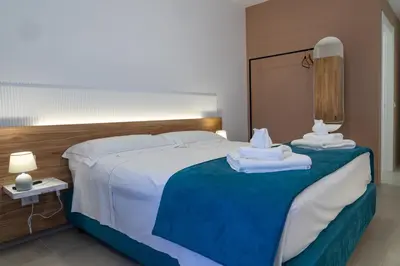 a hotel room with a bed with towels on it at B&B Alba in Terrasini