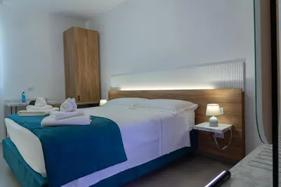 a bedroom with a large bed with towels on it at B&B Alba in Terrasini