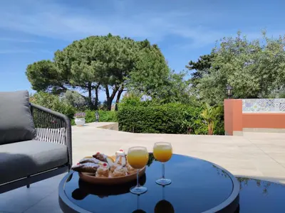 a table with a bowl of food and two glasses of orange juice at Panoramic Villa 200m from the Sea with Heated Pool & Whirpool in Terrasini