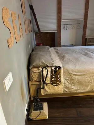 a bed in a room with a scale next to it at Casa Design con terrazzo in centro storico a Palermo in Palermo