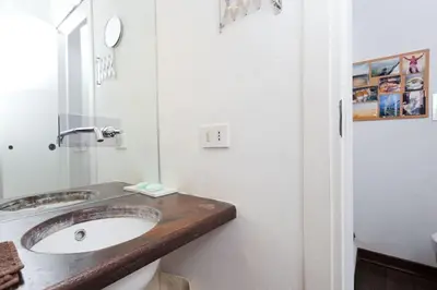 a bathroom with a sink and a mirror at Casa Design con terrazzo in centro storico a Palermo in Palermo