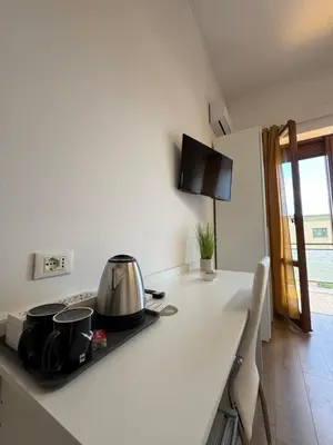 a room with a desk and a table with a chair at Crispi 120 Rooms New Opening in Palermo