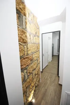 a room with a stone wall and a hallway at La chiave dei sogni in Palermo