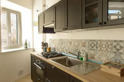 a kitchen with a sink and a stove at La Casa del Mercado in Palermo