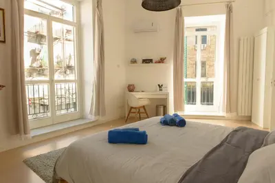 a bedroom with a bed with blue pillows on it at La Casa del Mercado in Palermo