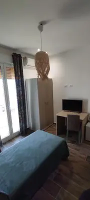 a bedroom with a bed and a table and a desk at Green Suite Palermo in Palermo