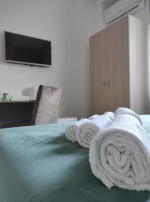 a hotel room with towels on a bed at Green Suite Palermo in Palermo