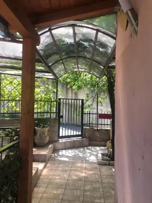 an outdoor patio with an arbor and a fence at IL PANORAMA in Altofonte