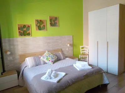 a bedroom with a bed with two towels on it at Casuzza Bedda e Duci in Mondello