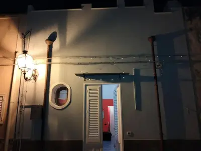 a hallway with a door and a window on a building at Dammuso SoleLuna. in Terrasini