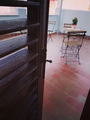 a door to a room with a table and chairs at Dammuso SoleLuna. in Terrasini