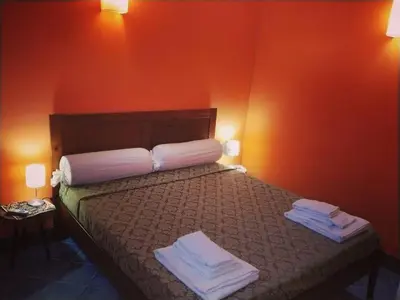 a hotel room with a bed with towels on it at Dammuso SoleLuna. in Terrasini