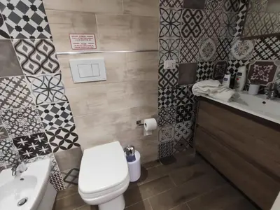 a bathroom with a toilet and a sink at Medea rooms palermo centro in Palermo