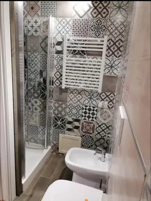 a bathroom with a toilet and a shower with tiles at Medea rooms palermo centro in Palermo
