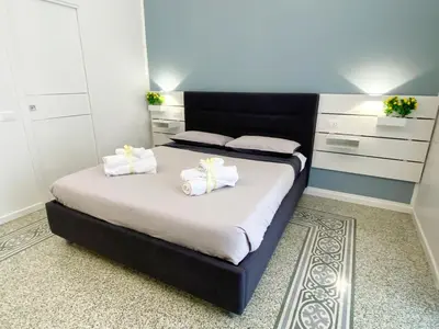 a bedroom with a bed with two white towels at Casa Granatelli in Palermo