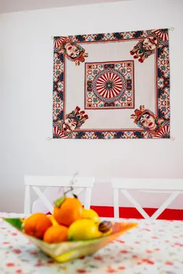 a bowl of fruit on a table in front of a picture at VILLA HEMINGWAY - LA Casa di Alessia e La Casa di Leonardo in Ficarazzi