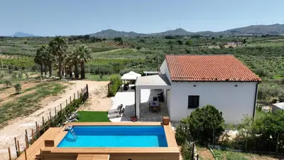 a villa with a swimming pool next to a house at Villa Marica in Partinico