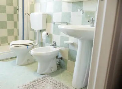 a bathroom with a toilet and a sink at Villa Marica in Partinico