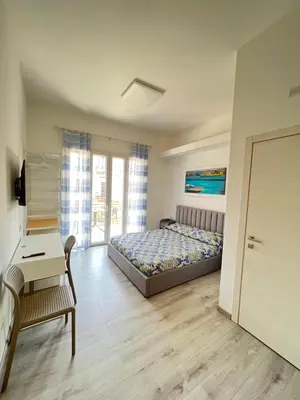 a bedroom with a bed and a table and a desk at Bella Vita Palermo in Palermo